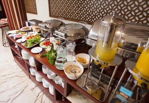 a buffet with food and drinks on a table at Midori Boutique Hotel in Hanoi