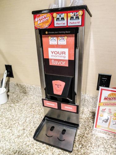 a video game machine with a smiling face on it at Comfort Suites Regina in Regina