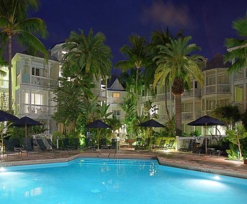 a swimming pool in front of a hotel at night at Hyatt Vacation Club at Sunset Harbor in Key West