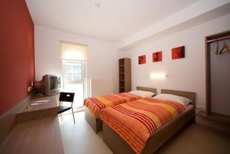 Postel nebo postele na pokoji v ubytování Nibelungenmotel Pöchlarn
