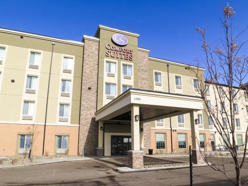 a large building with a clock on the front of it at Comfort Suites Regina in Regina