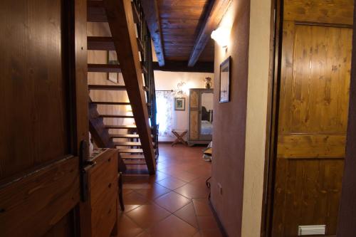 a hallway with a staircase in a house with a room at Agriturismo La Cascinetta in Pieve di Cento