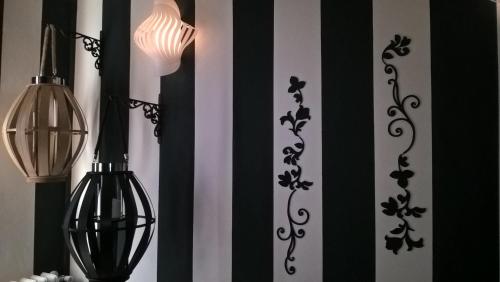 a room with black and white curtains and a lamp at Piccolo Relais Galletto di Marzo Spa e relax solo per due in Paciano