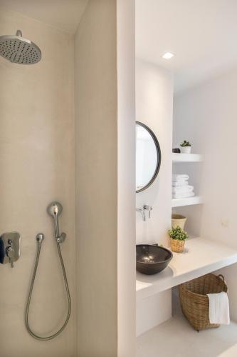 a bathroom with a shower and a sink at My Mykonos Hotel in Mýkonos City
