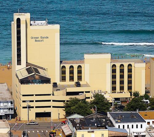 a large building on the beach with the ocean behind it at Ocean Sands Resort, Oceanfront, Virginia Beach by Vacatia in Virginia Beach