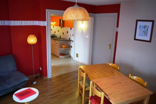 a living room with a wooden table and a dining room at Domaine du Port Sainte Marie in Maizières-lès-Vic