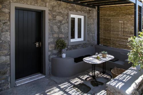 a patio with a table next to a door at My Mykonos Hotel in Mýkonos City