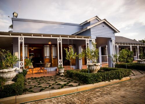 a house with a cobblestone yard in front of it at Mon-Ae Guesthouse in Klerksdorp