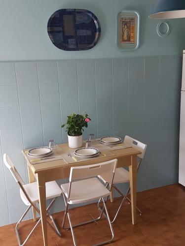 a wooden table with chairs and a potted plant on it at Accasamia Terricciola in Terricciola