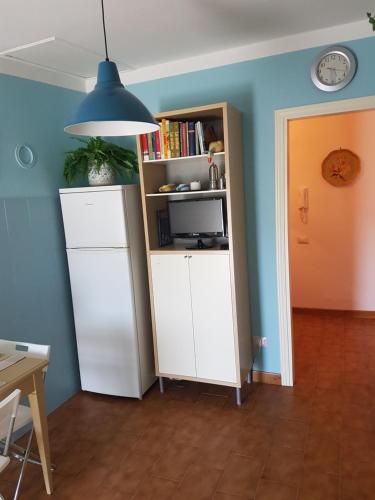 a room with a book shelf and a white cabinet at Accasamia Terricciola in Terricciola