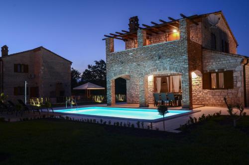 an external view of a villa with a swimming pool at Villa Harmony in Paradise in Svetvinčenat