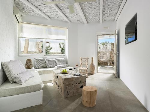 a living room with a couch and a table at Delmar Apartments & Suites Milos - Delmar Collection in Pollonia