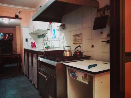 a kitchen with a stove and a tea kettle on it at Hostal Namaste in Salta