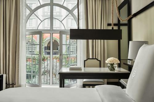 a bedroom with a bed and a desk and a window at Four Seasons Hotel Mexico City in Mexico City