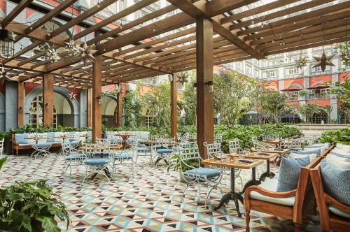 a patio with tables and chairs in a courtyard at Four Seasons Hotel Mexico City in Mexico City
