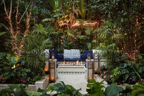 a bench in a garden with plants and lights at Four Seasons Hotel Mexico City in Mexico City