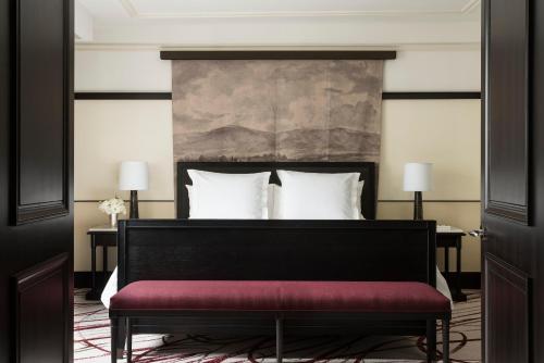 a bedroom with a bed with a red bench at Four Seasons Hotel Mexico City in Mexico City