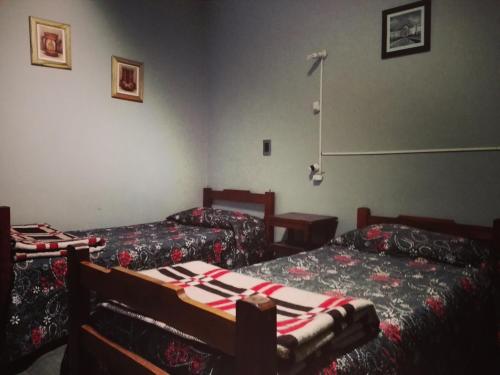 a room with two beds in a room at Hostal Namaste in Salta