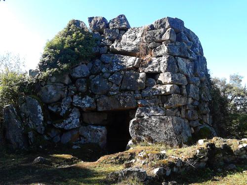 an old stone building sitting on top of a hill at B&B I Menhir in Sorgono