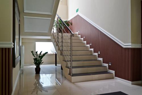 a staircase in a house with a vase at Hotel Dąbrowski in Oświęcim