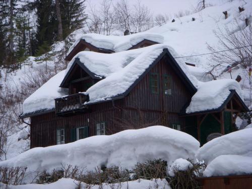 a cabin with snow on the roof of it at Franz Rudolf in Bad Aussee