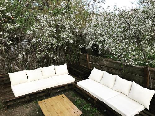 two white couches sitting in front of some trees at Miro Mara Boutique Hotel & Lounge Bar in Edremit