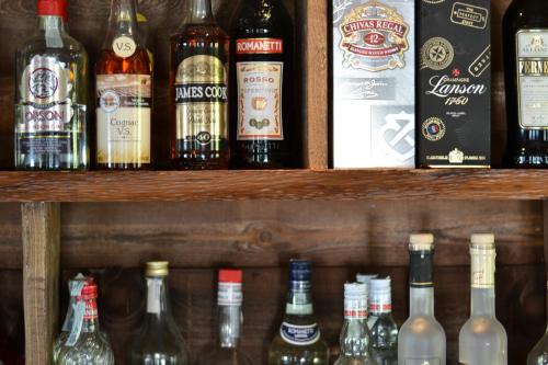 a shelf filled with different types of bottles of alcohol at Hotell Millefiori- Alpine Event Lodge in Valtournenche