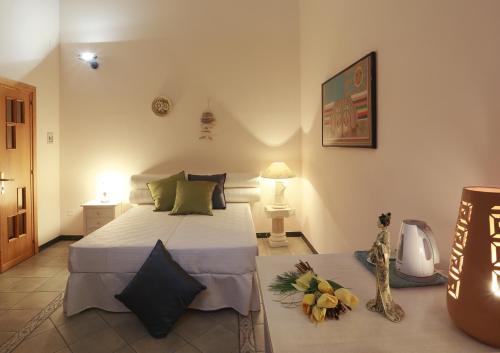 a bedroom with a bed and flowers on the floor at camera elena in Palazzo Stapane in Santa Maria al Bagno
