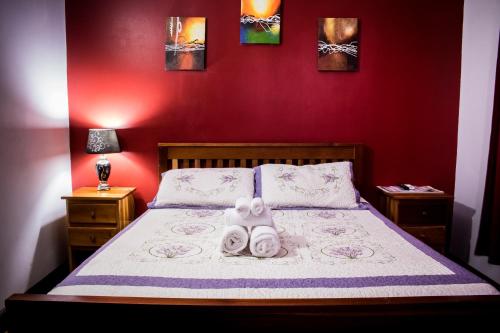 a bedroom with a bed with two towels on it at Serenade Hotel in Placencia Village