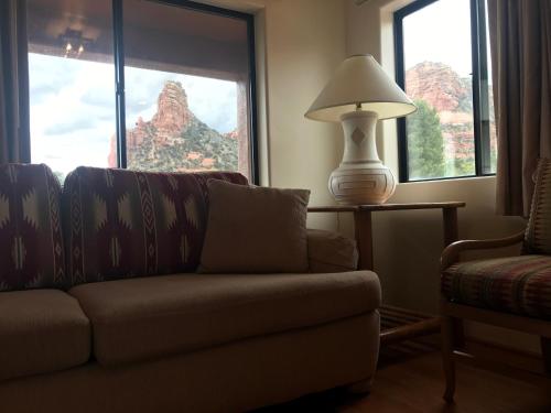 a living room with a couch and a lamp at Sedona Village Lodge in Sedona