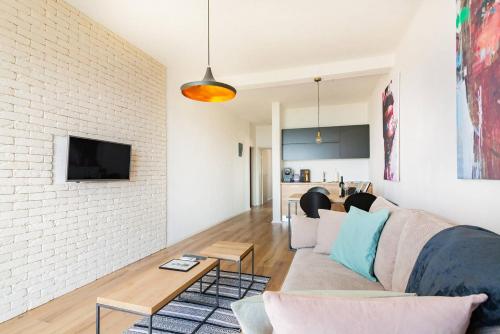 a living room with a couch and a brick wall at VilaA21 in Bar