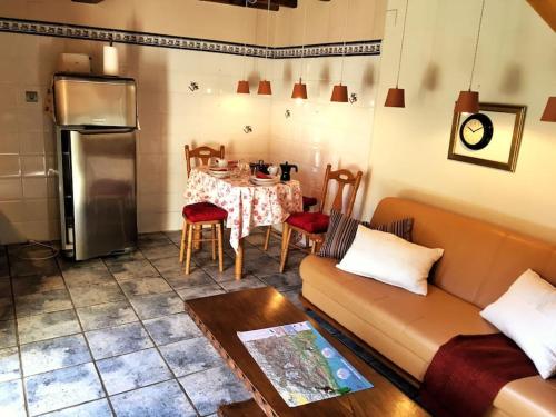 sala de estar con sofá y mesa con cocina en Sol de Asturias, en Cazo