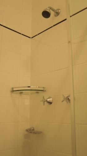 a shower with a glass door with stars on it at Katoomba Hotel in Katoomba