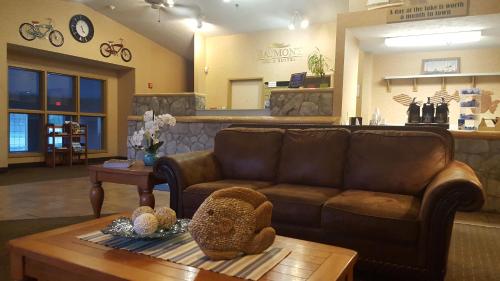 a living room with a couch and a coffee table at Baymont by Wyndham Coeur D Alene in Coeur d'Alene