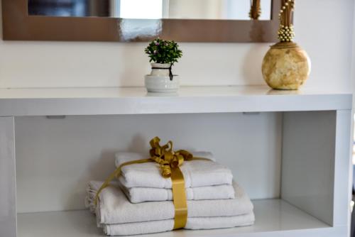 a white counter with towels on a shelf at Villa Premier in Ulcinj