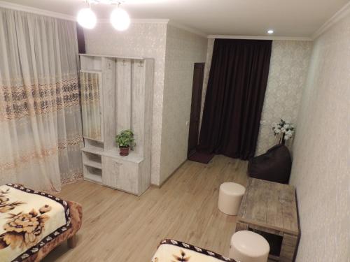 a living room with a couch and a table at Roza Guesthouse in Stepantsminda