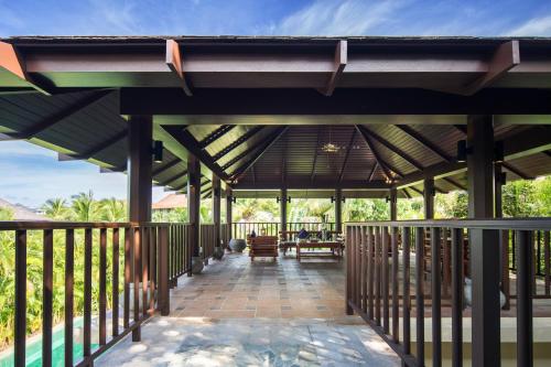 a pavilion with a table and chairs on a patio at Sanya Yalong Bay Villas & Spa in Sanya