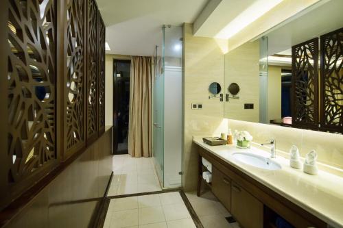 a bathroom with a sink and a mirror at Sanya Yalong Bay Villas & Spa in Sanya