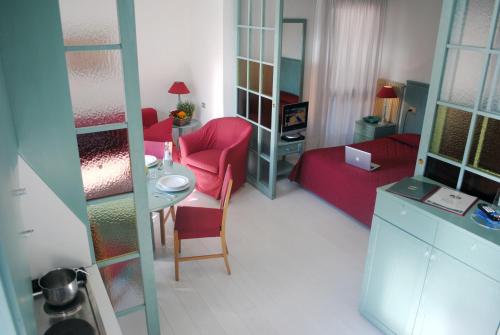 a small room with a red couch and a table at Residence Antares in Madonna di Campiglio