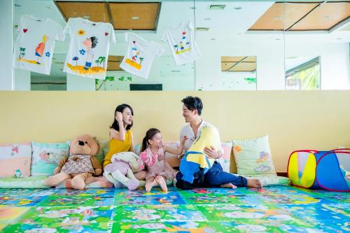 a family sitting on the floor with their teddy bears at Sanya Yalong Bay Villas & Spa in Sanya