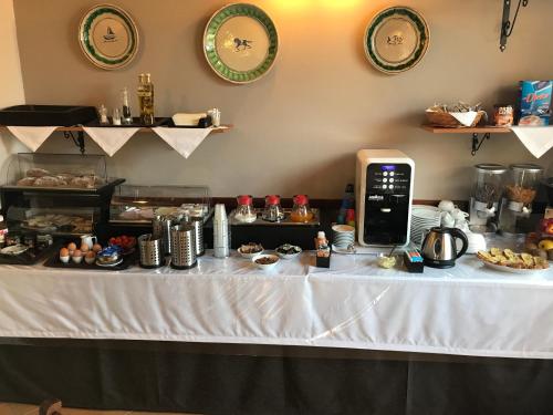 a table with a white table cloth with food on it at B&B Villa Eben Ezer in Avola