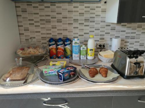 a counter with some food and drinks on it at B&B Les Chambres Rooms & Suite in Santa Teresa Gallura