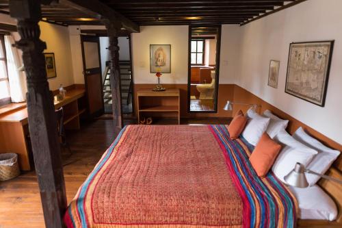 a bedroom with a large bed in a room at Milla Guesthouse Bhaktapur in Bhaktapur