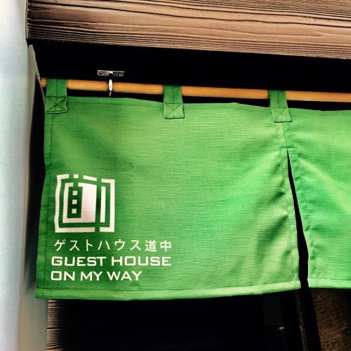 a green bag with a guest house on my way at Guest House On My Way in Sapporo