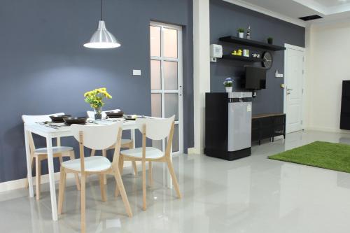 a kitchen and dining room with a table and chairs at A18 in Nonthaburi