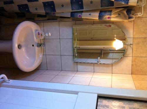 a urinal in a bathroom with a mirror at Eleana Studios in Lefkada