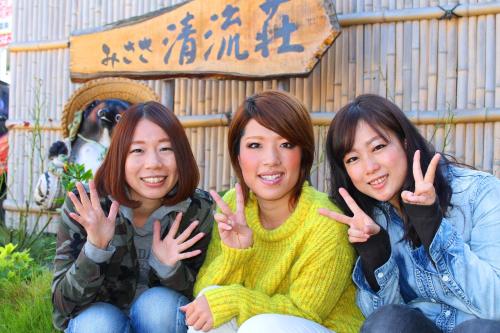 three women sitting next to each other giving the peace sign at Seiryuso in Misasa