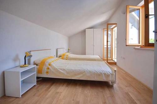 En eller flere senge i et værelse på Apartments Miodrag