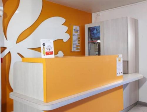 a counter in a store with a white cloud on the wall at Première Classe Martigues in Martigues