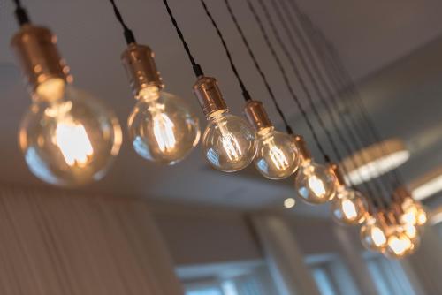 a bunch of light bulbs hanging from a ceiling at Hotel Weiss Kreuz in Thusis